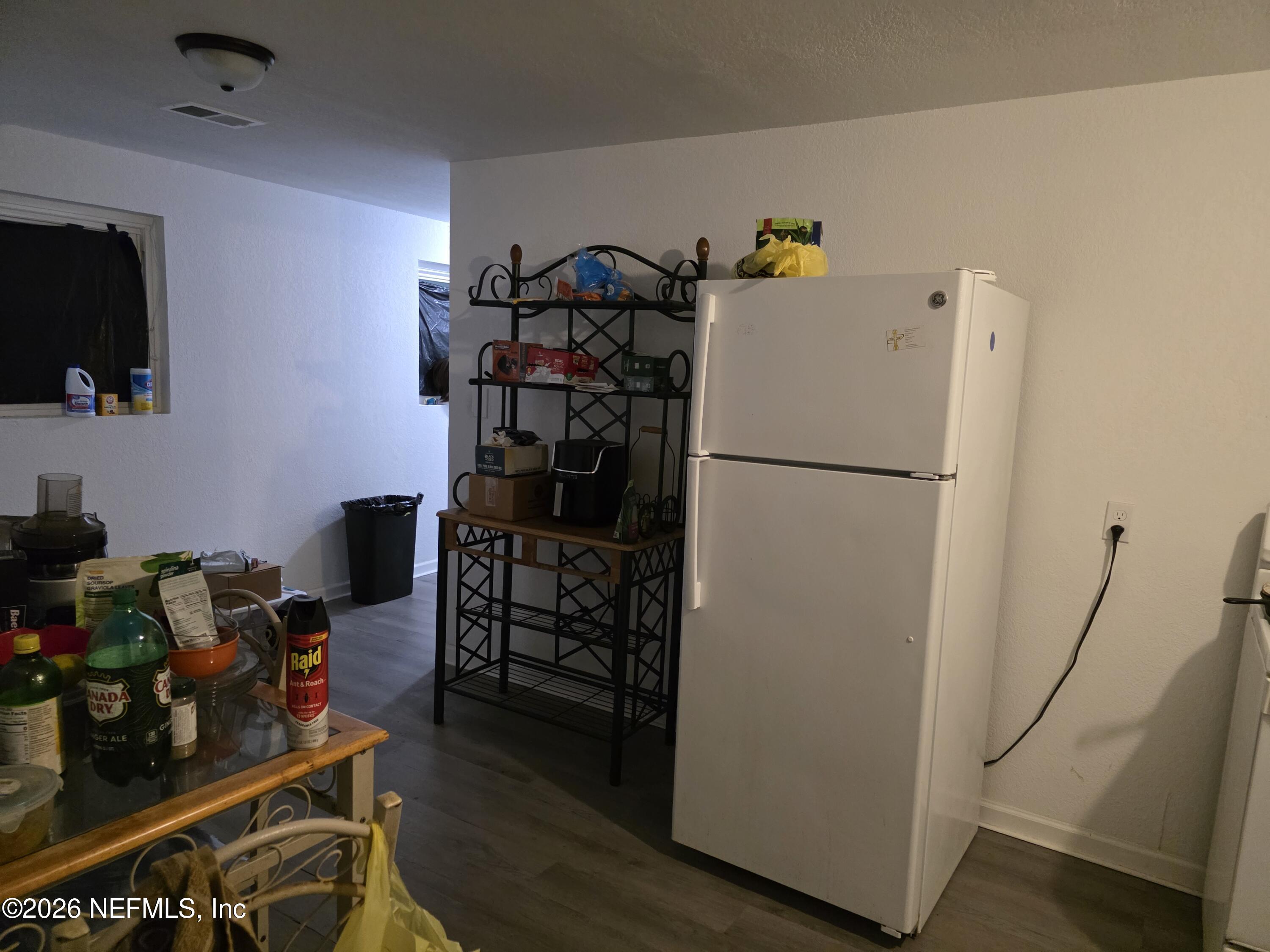 1949 West 6th Street Jacksonville, FL 32209 - Photo 12 of 15 a white refrigerator freezer sitting inside of a kitchen