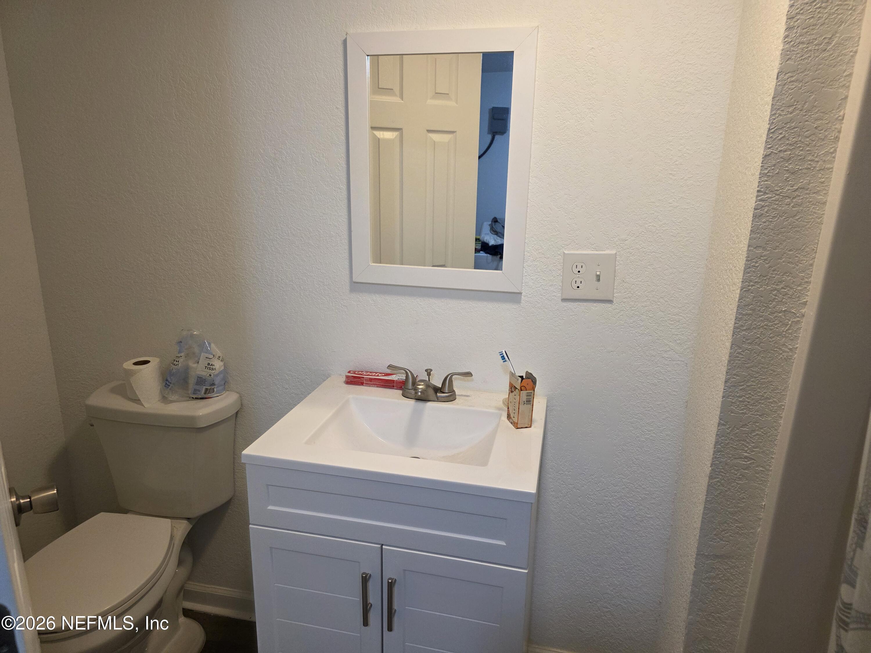 1949 West 6th Street Jacksonville, FL 32209 - Photo 5 of 15 a bathroom with a sink mirror and toilet