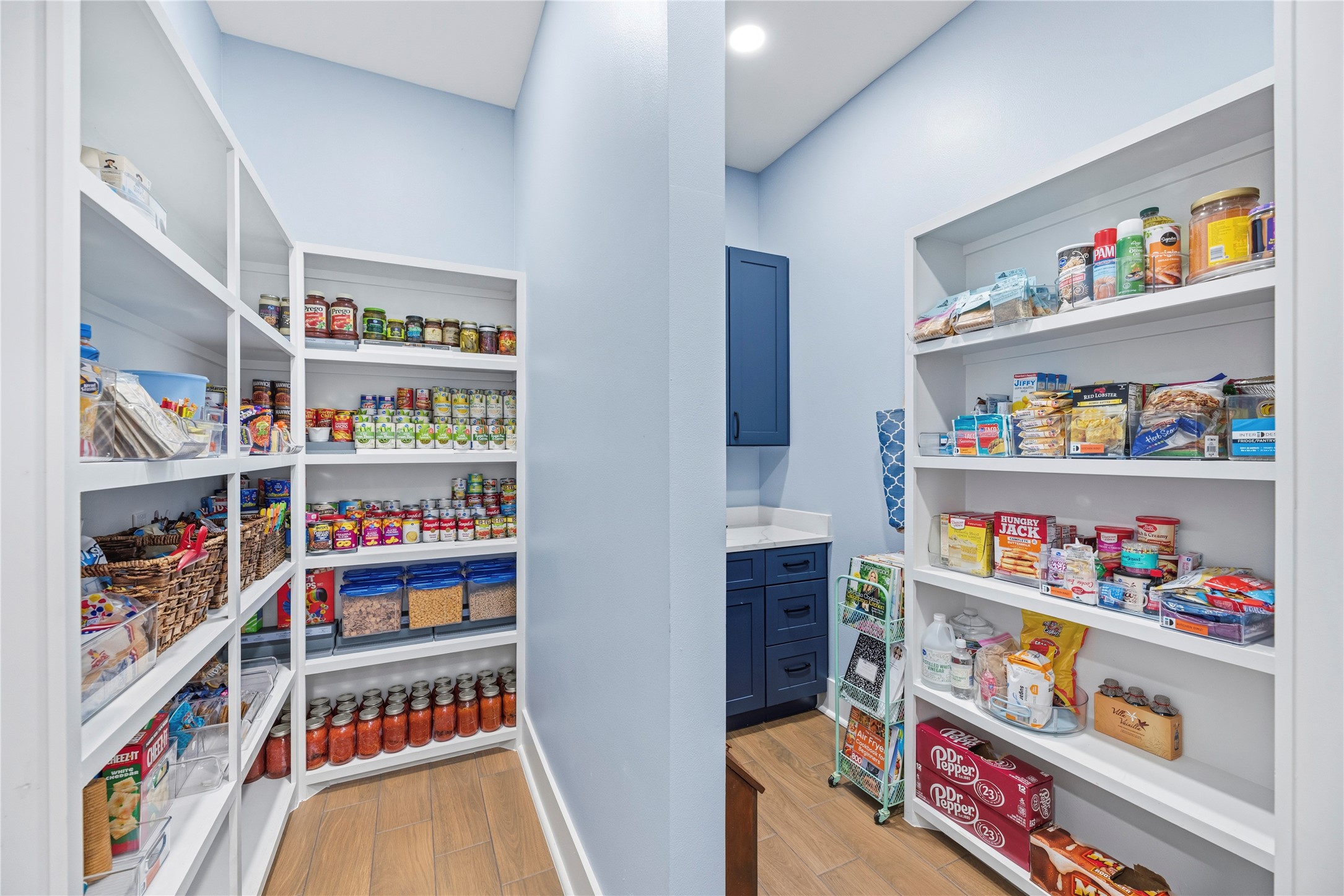 4607 Clayhead Road Richmond, TX 77406 - Photo 11 of 49 Exceptional walk-in pantry with extensive custom shelving and dedicated prep space, blending everyday functionality with luxury organization.