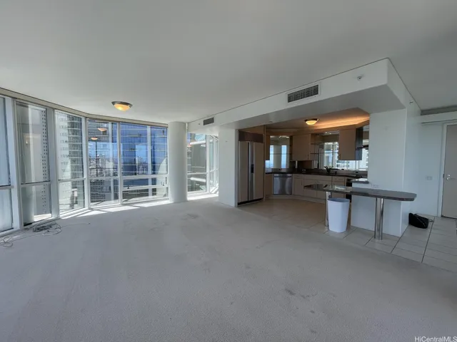 a view of a big room with windows and cabinet