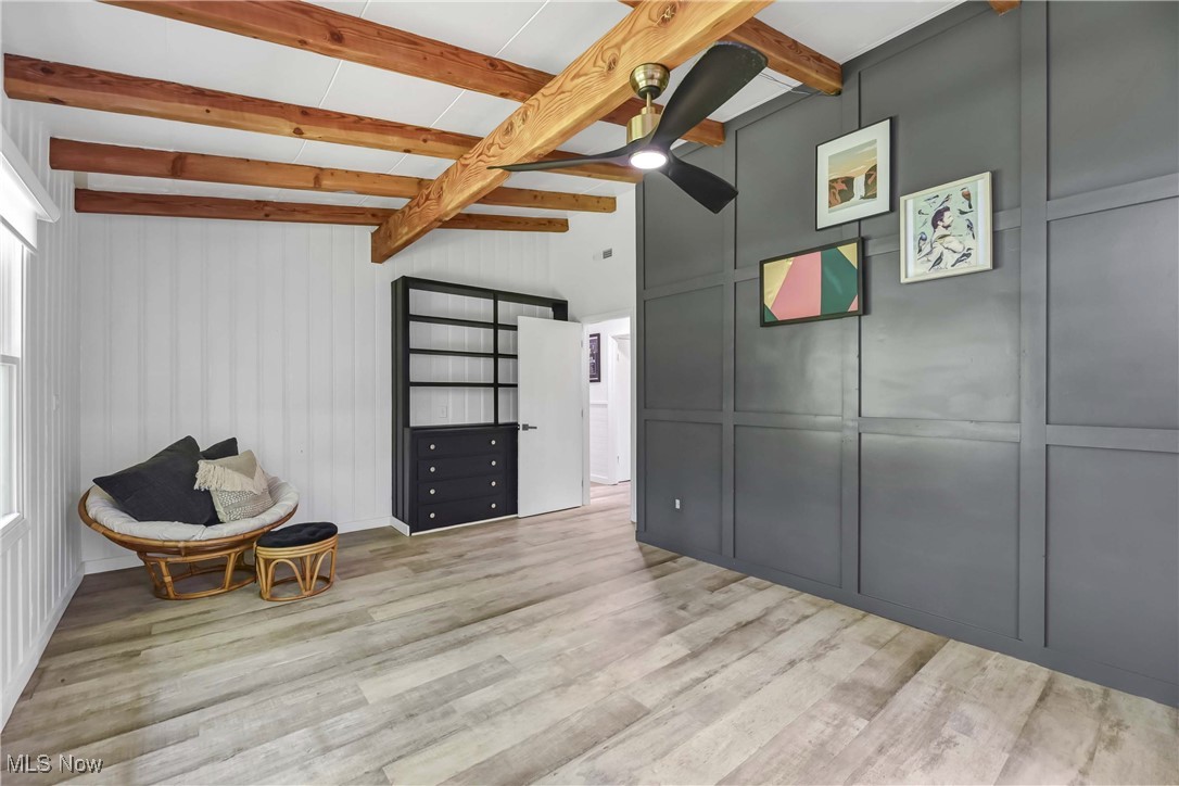 17575 Ridge Road North Royalton, OH 44133 - Photo 24 of 42 View of built-in, wood accent wall, beamed ceiling, fan and vinyl plank floors