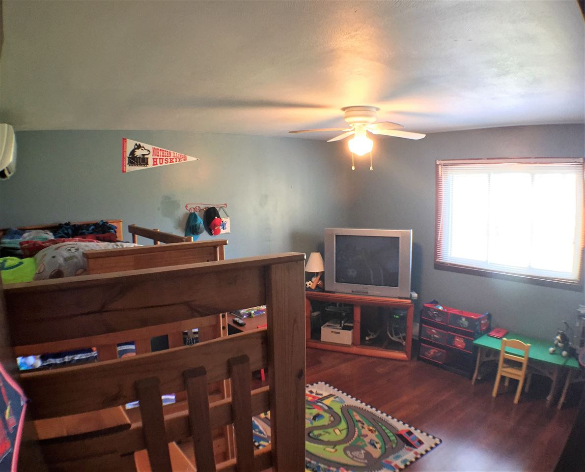 11578 Comly Rd. Winnebago, IL 61088 - Photo 12 of 23 a living room with furniture and a flat screen tv