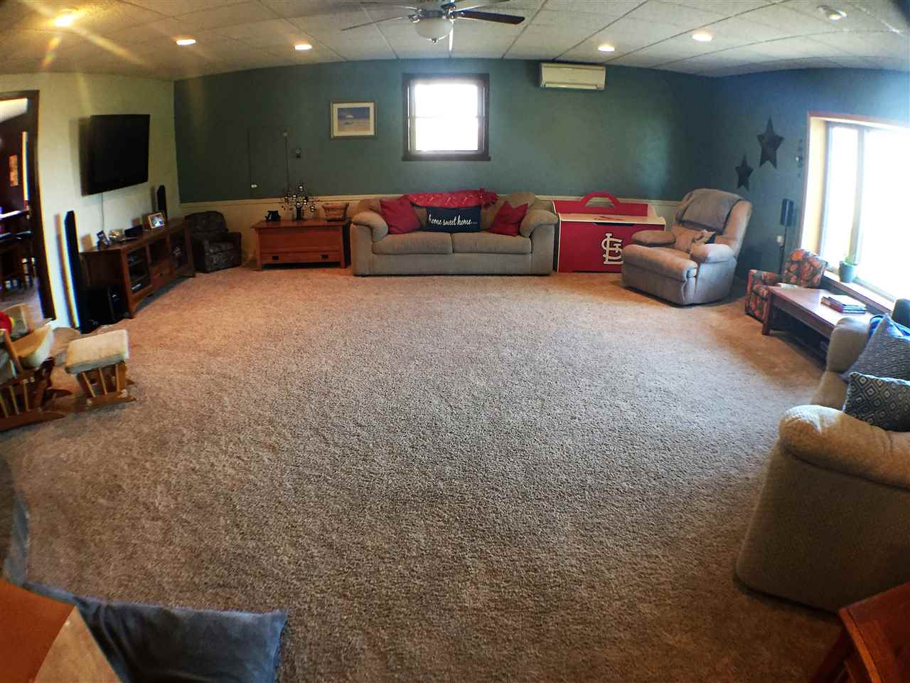 11578 Comly Rd. Winnebago, IL 61088 - Photo 2 of 23 a living room with furniture a flat screen tv and a window