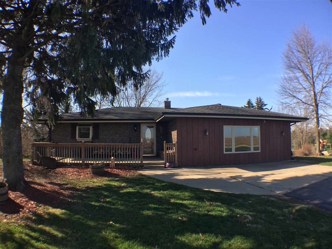 11578 Comly Rd. Winnebago, IL 61088 - Photo 22 of 23 a view of a yard in front of a house with large tree