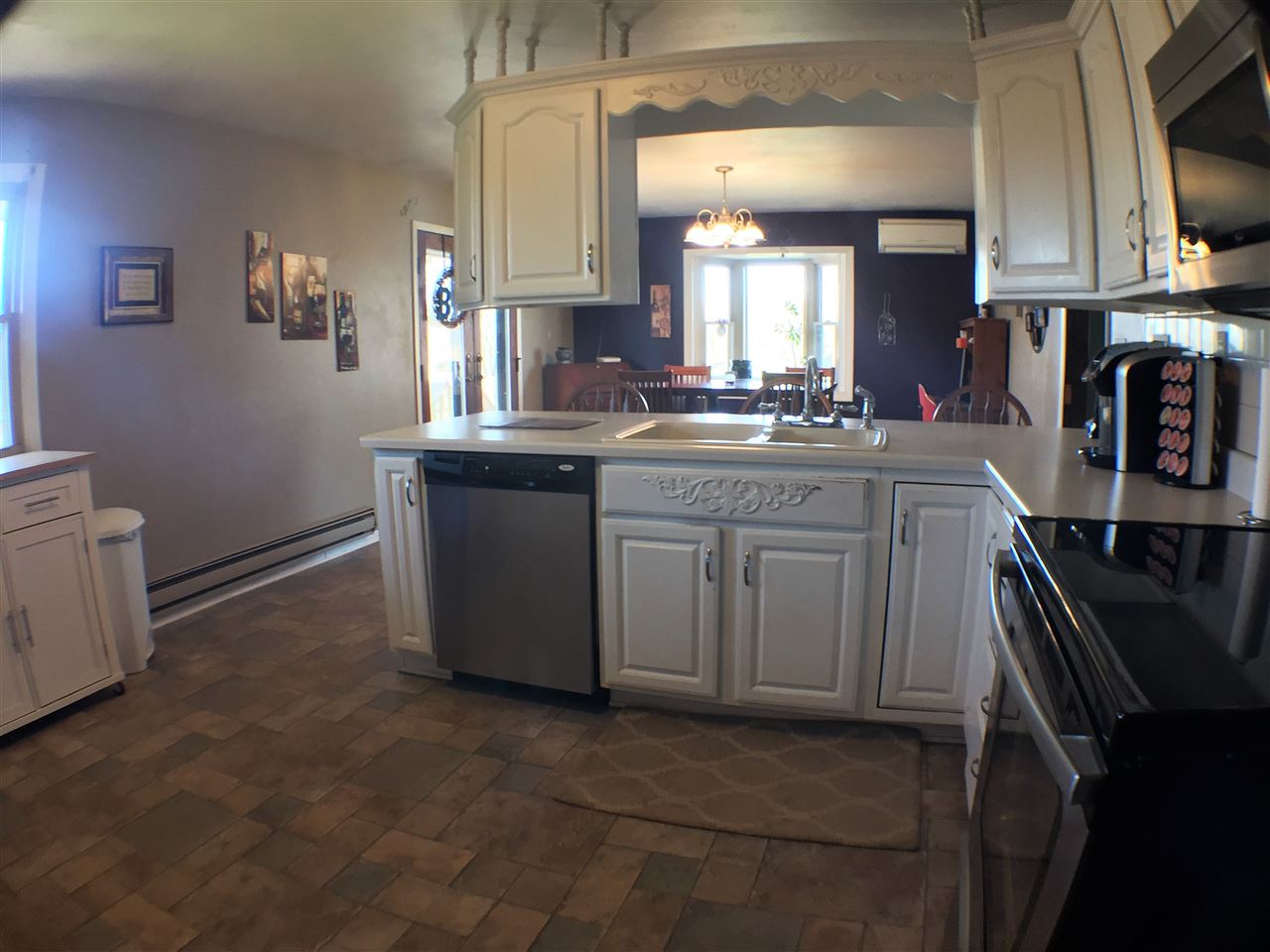 11578 Comly Rd. Winnebago, IL 61088 - Photo 5 of 23 a kitchen with kitchen island granite countertop a sink stove and cabinets