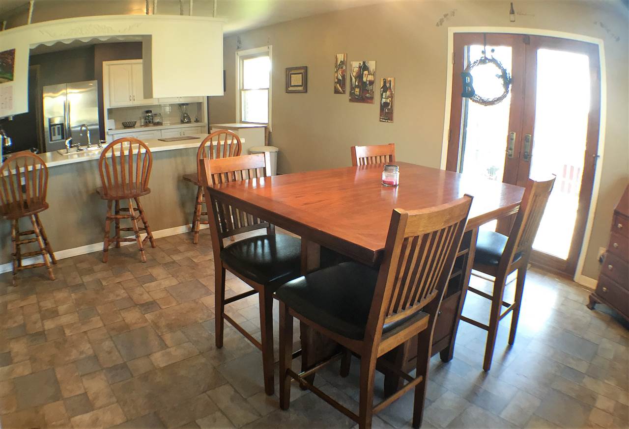 11578 Comly Rd. Winnebago, IL 61088 - Photo 7 of 23 a view of a dining room with furniture and wooden floor