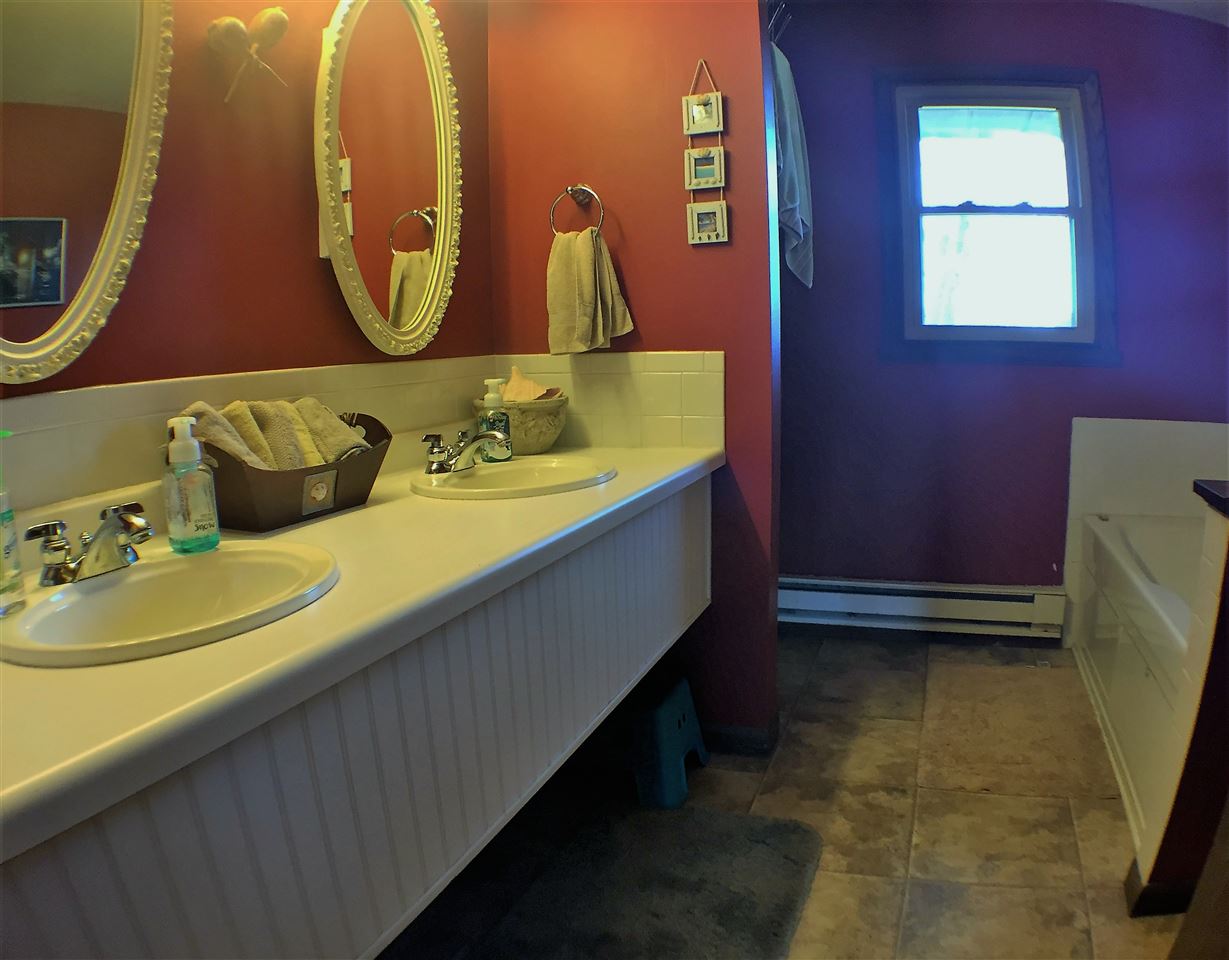 11578 Comly Rd. Winnebago, IL 61088 - Photo 9 of 23 a bathroom with a sink and a mirror