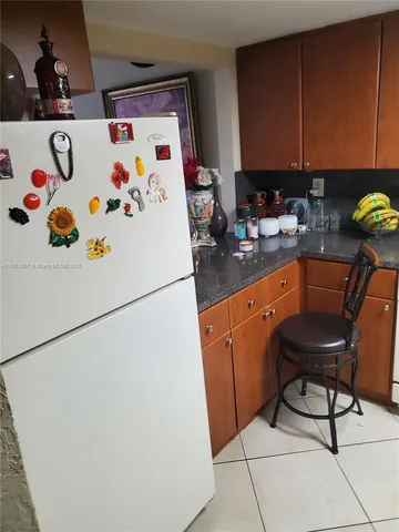 a white refrigerator freezer sitting inside of a kitchen