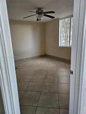a view of an empty room and a window