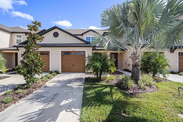 a front view of house with yard and green space