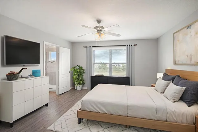 a spacious bedroom with a large bed and a flat screen tv