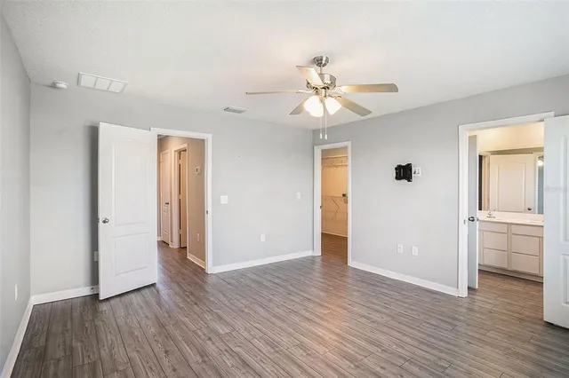 a view of an empty room with wooden floor