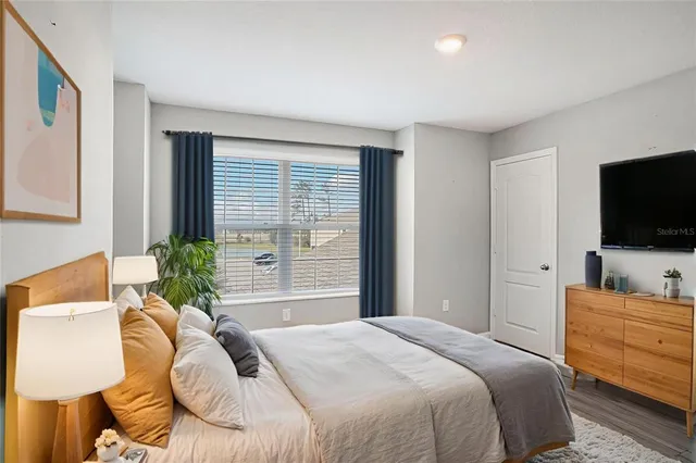 a bedroom with a bed and a flat screen tv