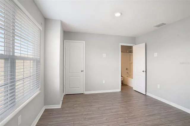 a view of wooden floor and windows in a room