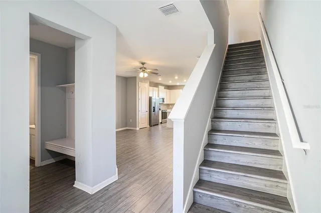 a view of a hallway with wooden floor and entryway
