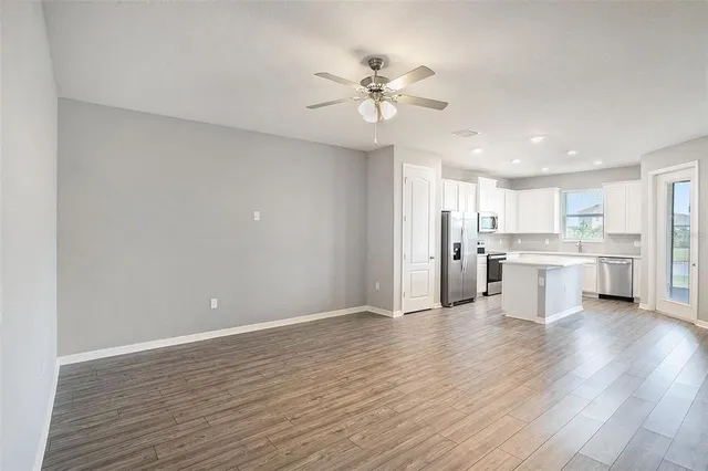 a view of a kitchen with wooden floor and a kitchen