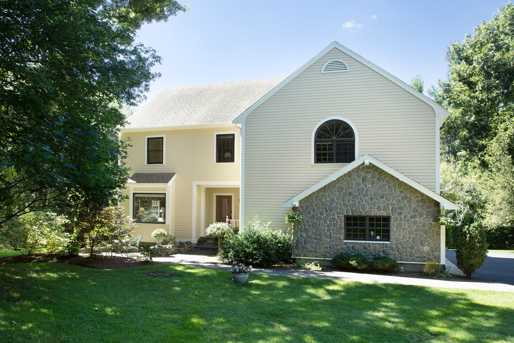 2 Ryer Lane Middleton, MA 01949 - Photo 1 of 16 a front view of a house with a yard and garage