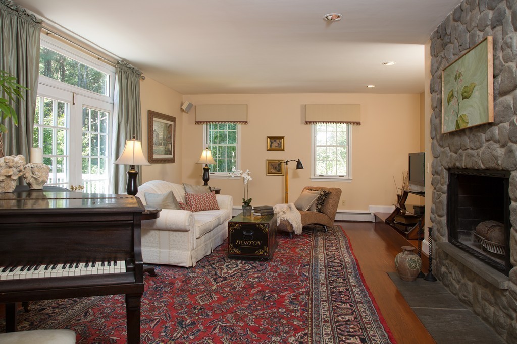2 Ryer Lane Middleton, MA 01949 - Photo 5 of 16 a living room with furniture two windows and a fireplace