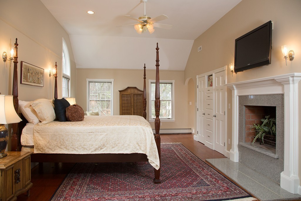 2 Ryer Lane Middleton, MA 01949 - Photo 7 of 16 a bedroom with a bed a flat screen tv and chandelier