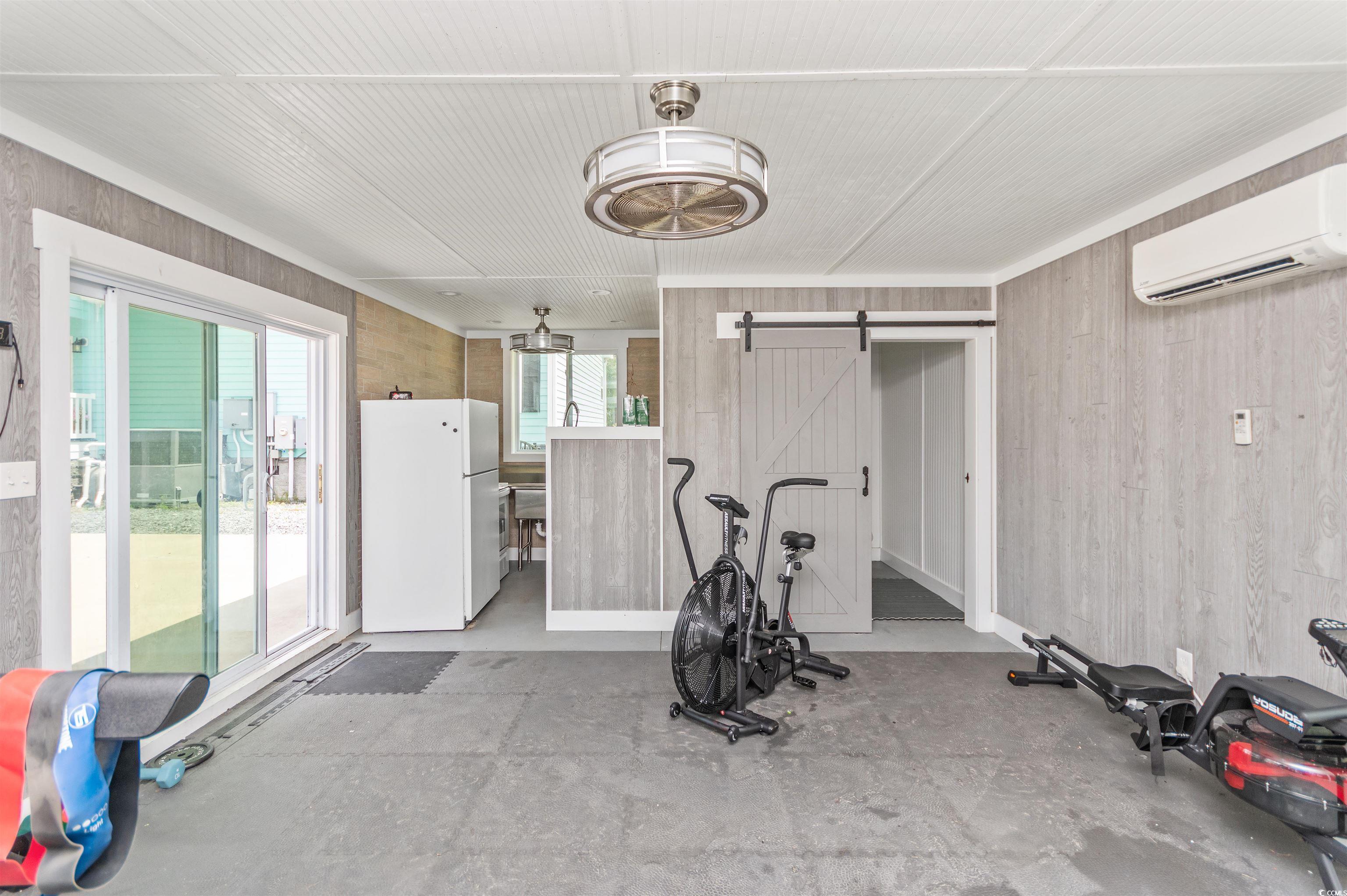 510 Council Bluff Road Longs, SC 29568 - Photo 33 of 40 Workout room with wooden walls, a barn door, a wal