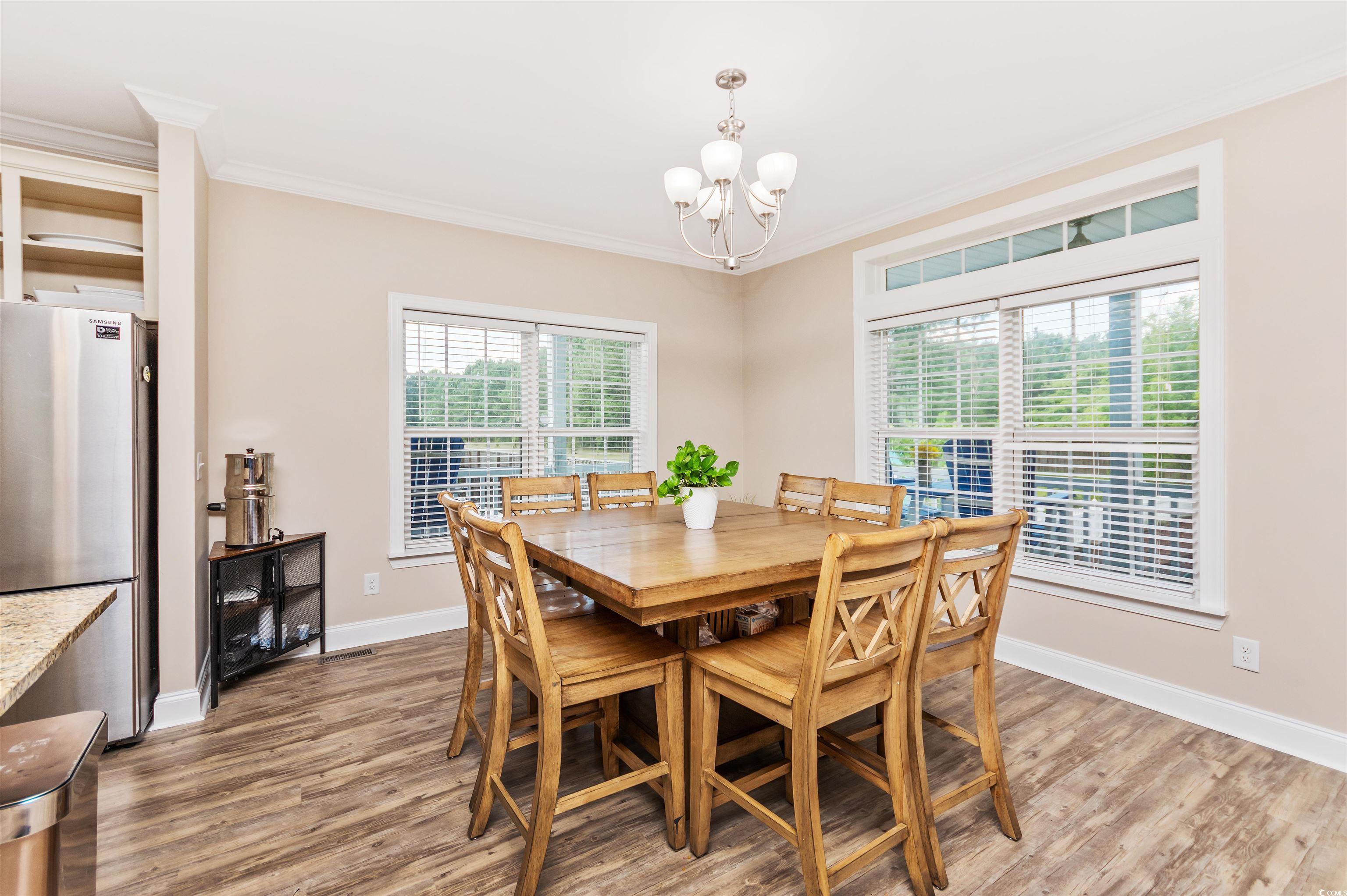 510 Council Bluff Road Longs, SC 29568 - Photo 9 of 40 Dining area featuring crown molding, hardwood / wo