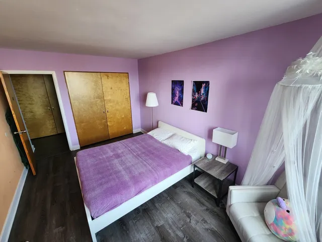 a bedroom with a bed and a mirror