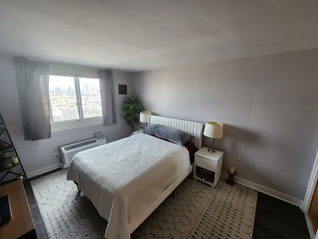 a bedroom with a bed and window