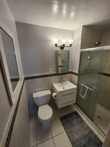 a bathroom with a toilet sink and mirror
