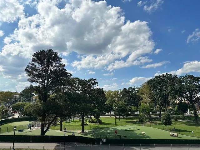 a view of a golf course with car parked