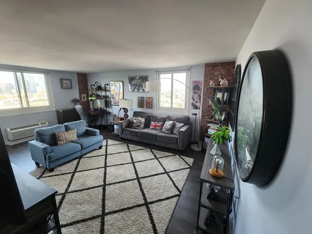 a living room with furniture and a mirror