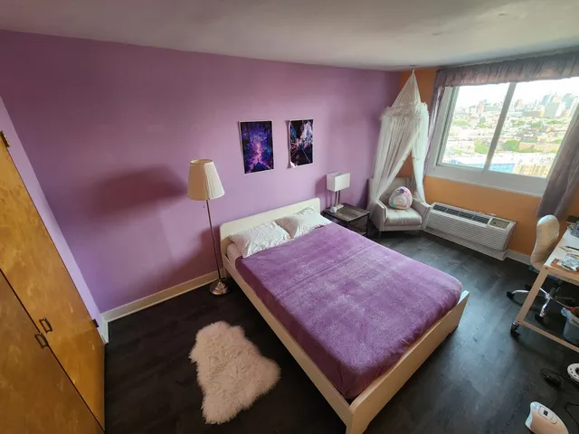 a bed room with a bed and a window