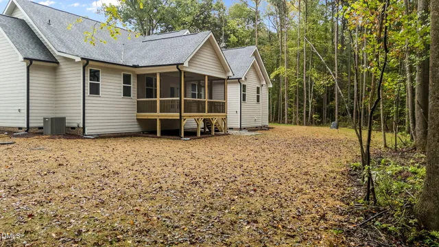 a view of an house with backyard space and balcony