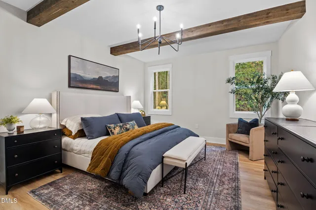 a bedroom with a bed dresser and a window