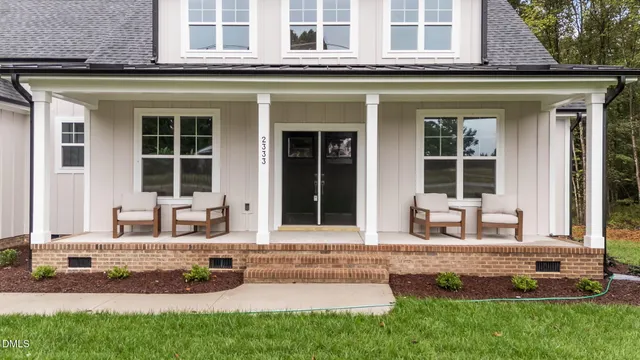 a front view of a house with a garden and porch