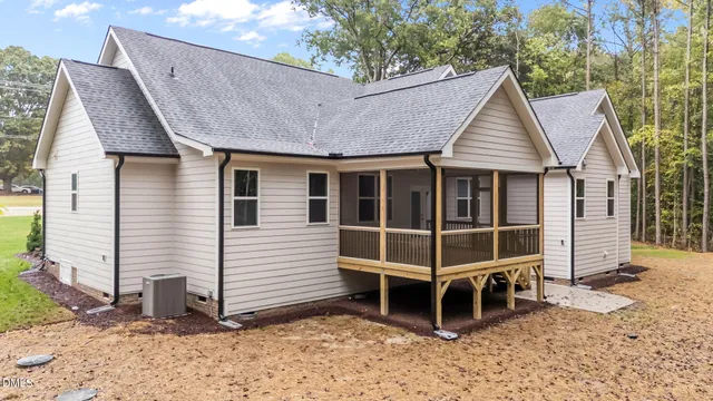 a view of a house with a yard and wooden fence