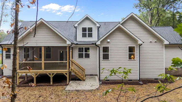 a view of a house with a yard and garage