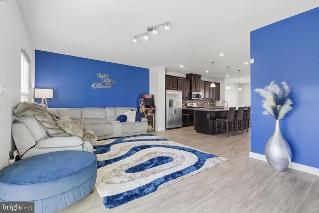 a living room with furniture and kitchen view