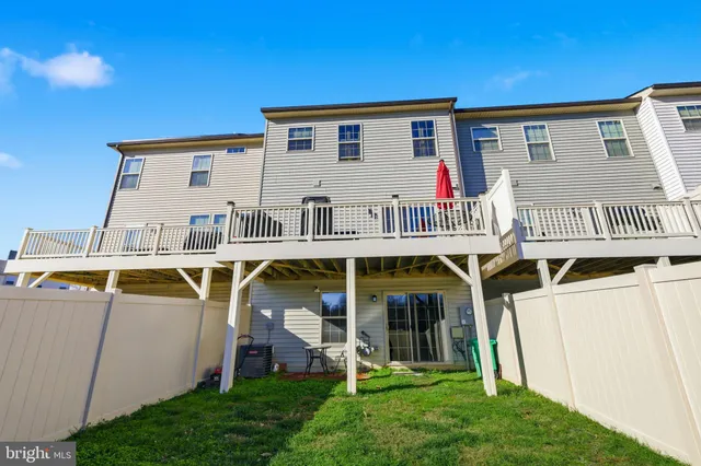 a view of small house with pool and chairs