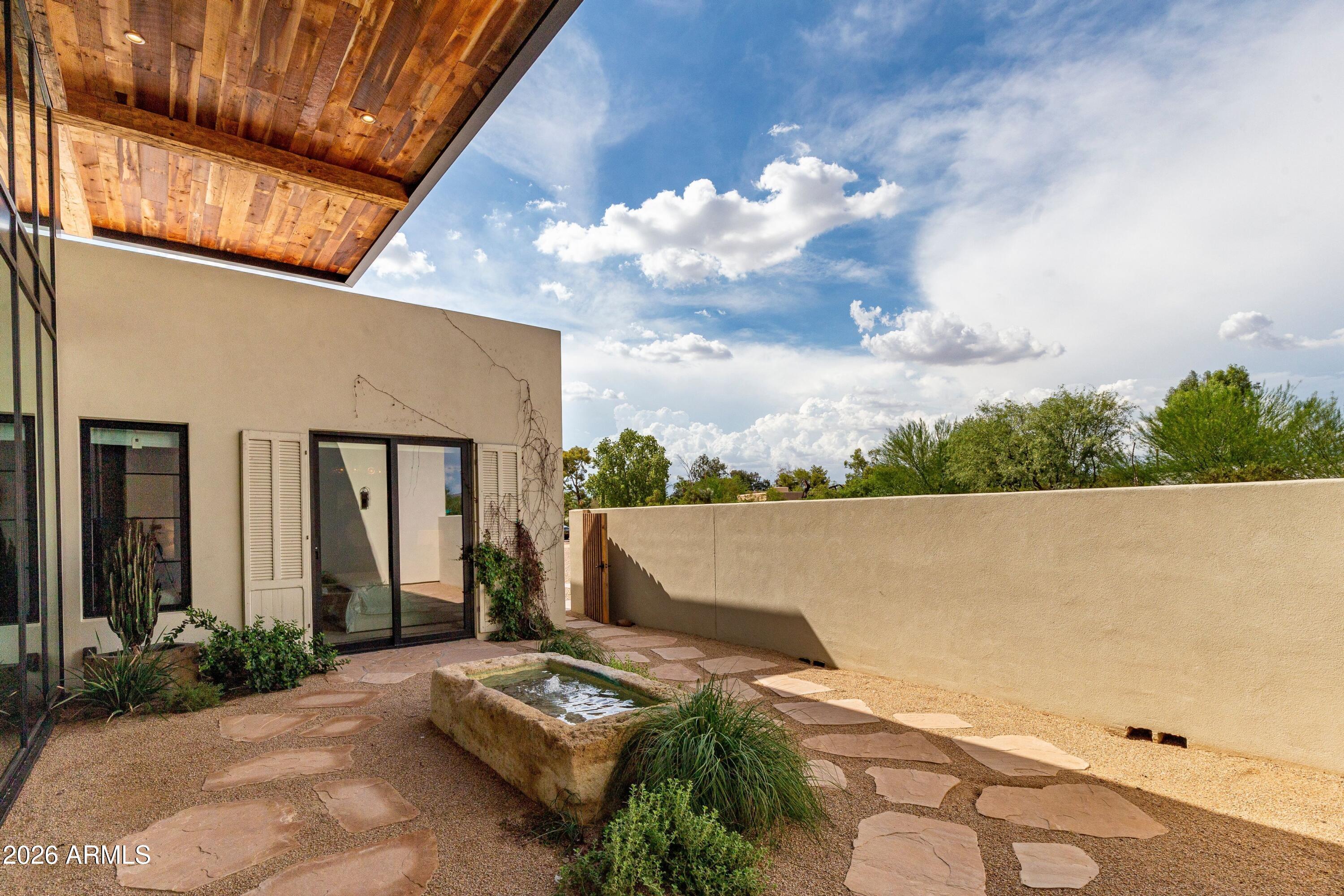 8307 East Gary Road Scottsdale, AZ 85260 - Photo 3 of 34 front view of house with a garden
