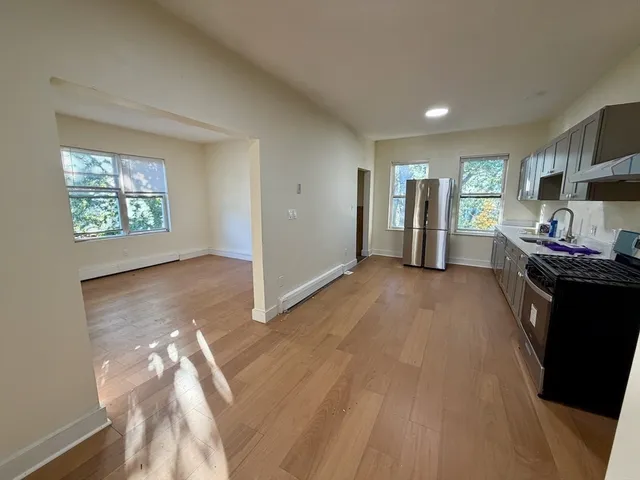 a view of a livingroom with furniture hardwood floor and a window