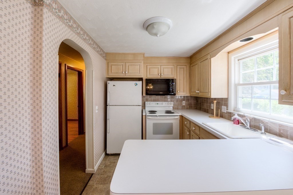 37 Endecott Street Springfield, MA 01118 - Photo 21 of 39 a kitchen with a refrigerator and a sink