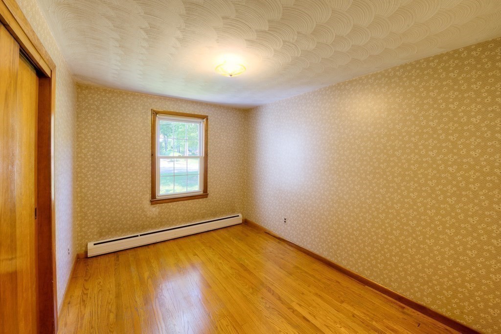 37 Endecott Street Springfield, MA 01118 - Photo 8 of 39 a view of an empty room with wooden floor and a window