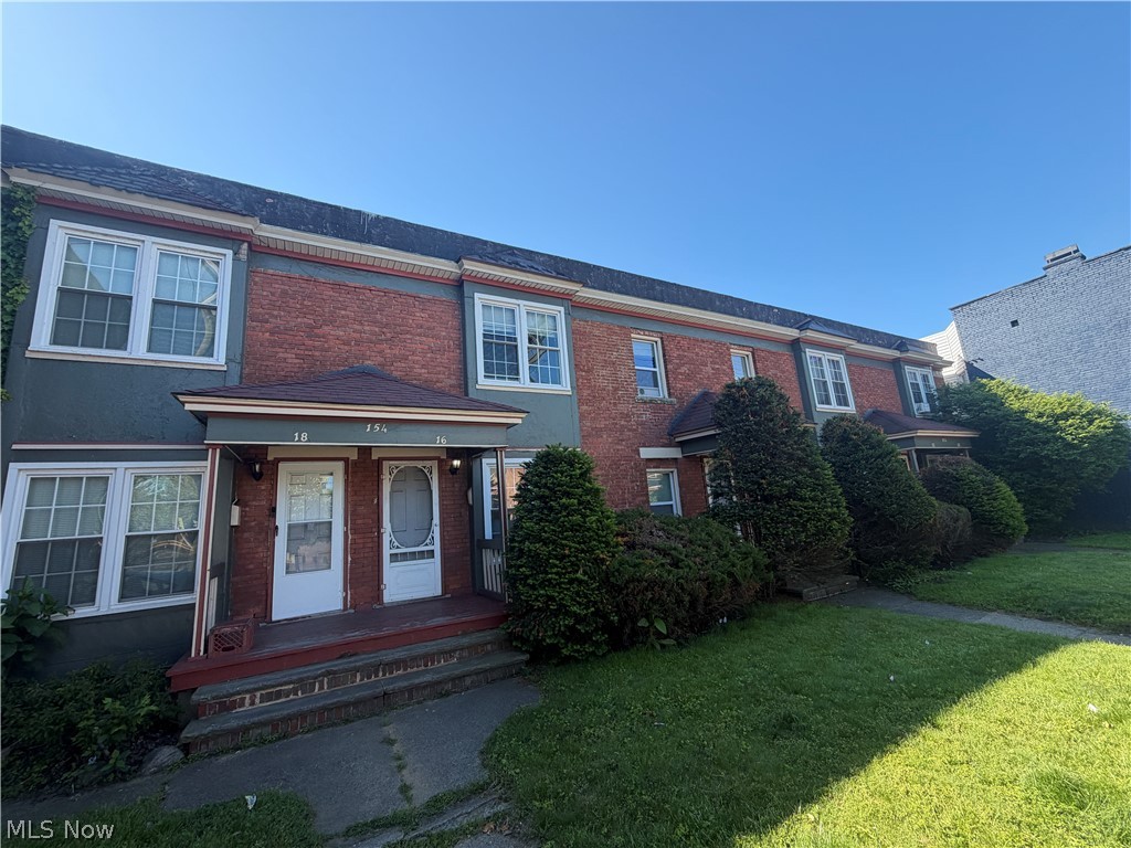 Brick and siding multi-unit property featuring individual covered entryways