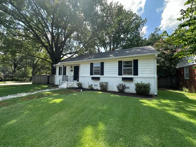 a front view of house with yard and green space