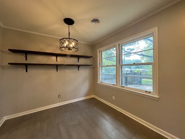 a view of a room with window and wooden floor