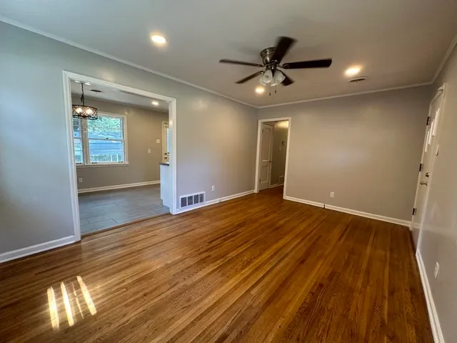 wooden floor in an empty room with a window