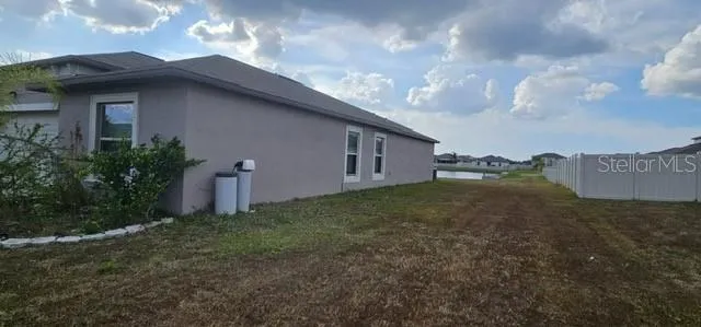 a backyard of a house with lots of green space and garden