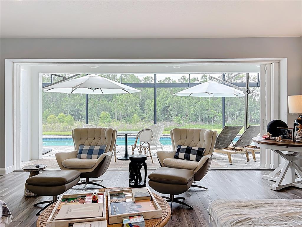 10220 Bay Lake Road Groveland, FL 34736 - Photo 17 of 67 a living room with furniture and floor to ceiling windows