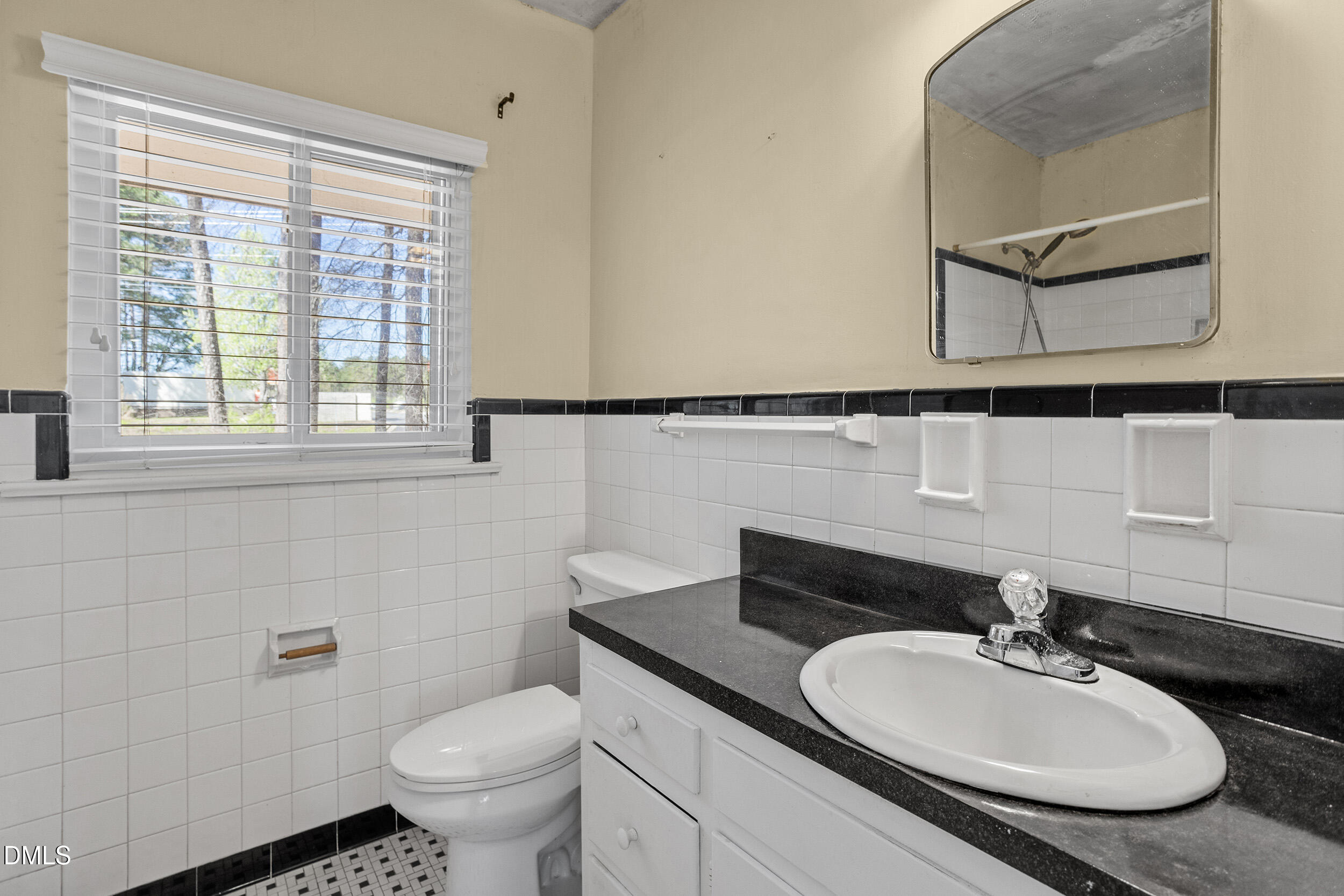 5011 Old Stage Road Raleigh, NC 27603 - Photo 23 of 29 a bathroom with a granite countertop sink and a mirror