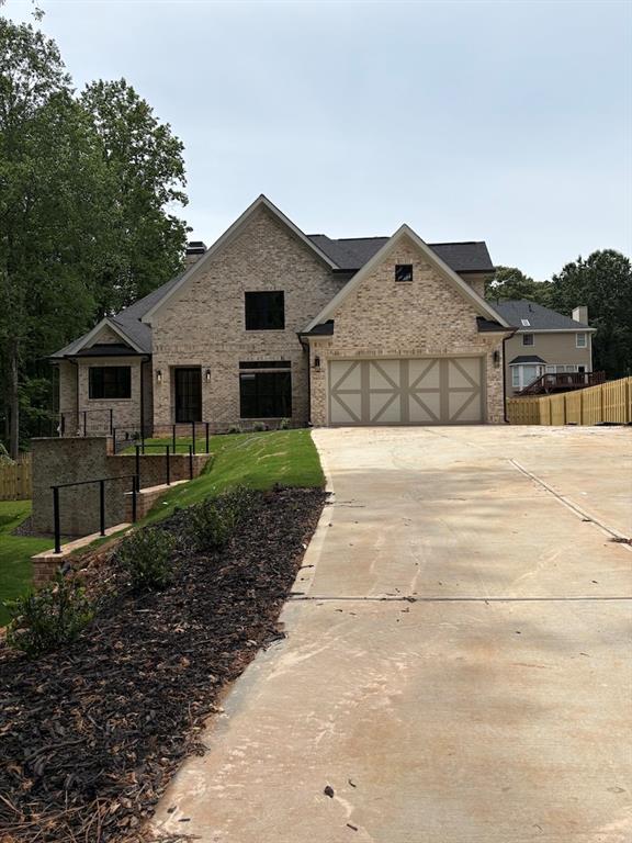 131 West Putnam Ferry Road Woodstock, GA 30189 - Photo 4 of 22 a front view of a house with a yard and garage